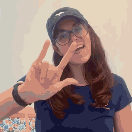 a gif with a woman doing the "i love you" ASL sign
